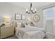 Serene bedroom with chandelier, and light colored bedding at 15430 W Hackamore Dr, Surprise, AZ 85387