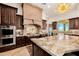 Gourmet kitchen with granite island, high-end appliances, and mountain views at 9127 N Vista Verde N Ct, Fountain Hills, AZ 85268