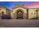 Elegant home entrance with iron doors and landscaping at 9127 N Vista Verde N Ct, Fountain Hills, AZ 85268