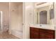 Clean bathroom with a tub, vanity, and mirror at 15228 W Elm St, Goodyear, AZ 85395