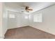 Spacious bedroom featuring ceiling fan and neutral carpeting at 1434 E Romley Ave, Phoenix, AZ 85040