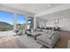 Open concept living room with L-shaped sectional sofa and mountain views at 14810 E Valley Vista Dr, Fountain Hills, AZ 85268