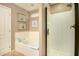 Bathroom with bathtub, shower, and updated fixtures at 13349 N 87Th Ln, Peoria, AZ 85381