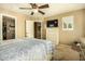 Bedroom with queen bed, dresser, and access to another room at 13349 N 87Th Ln, Peoria, AZ 85381