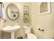 Small bathroom with pedestal sink and decorative accents at 13349 N 87Th Ln, Peoria, AZ 85381