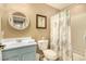 Small bathroom with teal vanity and shower/tub combo at 13349 N 87Th Ln, Peoria, AZ 85381