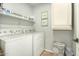 Laundry room with washer, dryer, and overhead shelving at 13349 N 87Th Ln, Peoria, AZ 85381