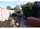 Landscaped backyard with hot tub, fire pit, and mature plants at 4506 E Lone Cactus Dr, Phoenix, AZ 85050