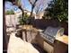 Outdoor kitchen with built-in grill and stone countertops at 4506 E Lone Cactus Dr, Phoenix, AZ 85050