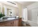 Bathroom with single sink vanity, tub, and shower at 28629 N Zircon Ct, San Tan Valley, AZ 85143