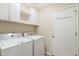 Laundry room with washer, dryer, and overhead cabinets at 28629 N Zircon Ct, San Tan Valley, AZ 85143