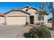 Tan house with a beige garage door and landscaped front yard at 28629 N Zircon Ct, San Tan Valley, AZ 85143