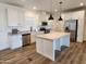 Modern kitchen with white cabinets, a center island, and stainless steel appliances at 301 N Brower Rd, Maricopa, AZ 85139