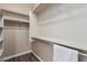 Spacious walk-in closet with built-in shelves and hanging rods at 9550 E Thunderbird Rd # 155, Scottsdale, AZ 85260