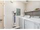 Laundry room with washer, dryer, and extra shelving at 9550 E Thunderbird Rd # 155, Scottsdale, AZ 85260