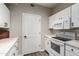 Clean kitchen with white cabinets, electric stove, and microwave at 9550 E Thunderbird Rd # 155, Scottsdale, AZ 85260
