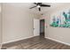 Bright bedroom with wood-look floors, ceiling fan, and artwork at 9550 E Thunderbird Rd # 155, Scottsdale, AZ 85260