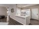 Modern kitchen with white cabinetry and breakfast bar at 9550 E Thunderbird Rd # 155, Scottsdale, AZ 85260