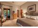 Spacious bedroom with king-size bed and access to patio at 9533 E Rising Sun Dr, Scottsdale, AZ 85262