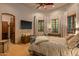 Comfortable guest bedroom with a queen-size bed and large windows at 9533 E Rising Sun Dr, Scottsdale, AZ 85262