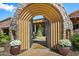 Stone courtyard with arched entryway and seating area at 9533 E Rising Sun Dr, Scottsdale, AZ 85262