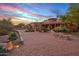 Long brick driveway leading to a charming stone house at 9533 E Rising Sun Dr, Scottsdale, AZ 85262