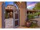 View through the gate to the entrance of the house at 9533 E Rising Sun Dr, Scottsdale, AZ 85262