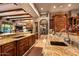 Large kitchen with double sink, granite counters and custom cabinetry at 9533 E Rising Sun Dr, Scottsdale, AZ 85262