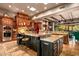 Open kitchen with large island, granite countertops, and custom cabinetry at 9533 E Rising Sun Dr, Scottsdale, AZ 85262