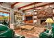 Living room with stone fireplace and mountain views at 9533 E Rising Sun Dr, Scottsdale, AZ 85262