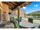 Covered patio with dining table, comfortable seating, and mountain views at 9533 E Rising Sun Dr, Scottsdale, AZ 85262