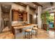 Custom wet bar with granite countertop and wooden cabinetry at 9533 E Rising Sun Dr, Scottsdale, AZ 85262