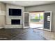 Living room with fireplace, sliding doors to patio, and dark hardwood floors at 11809 S Warpaint Dr, Phoenix, AZ 85044