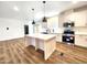 Modern kitchen with white cabinets and an island at 310 N Brower Rd, Maricopa, AZ 85139