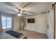 Spacious bedroom with ceiling fan, large mirror, and barn door at 823 S Silvercreek Ct, Casa Grande, AZ 85122