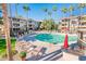 Community pool with lounge chairs, umbrellas, and BBQ area at 14950 W Mountain View Blvd # 1305, Surprise, AZ 85374
