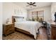 Bright bedroom with a queen bed, wood furniture, and tiled floor at 14950 W Mountain View Blvd # 1305, Surprise, AZ 85374
