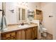 Bathroom with wood vanity, tiled floor, and shower at 14950 W Mountain View Blvd # 1305, Surprise, AZ 85374