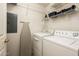 Laundry room with washer, dryer, and shelving at 14950 W Mountain View Blvd # 1305, Surprise, AZ 85374
