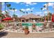Community pool with plenty of lounge chairs and umbrellas at 14950 W Mountain View Blvd # 1305, Surprise, AZ 85374