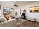 Comfortable living room with patio access and a view to the kitchen at 14950 W Mountain View Blvd # 1305, Surprise, AZ 85374