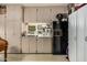 Small kitchenette in garage with cabinets and fridge at 4609 E Valley View Dr, Phoenix, AZ 85044