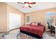 Bright bedroom with a large bed, double closets and ceiling fan at 38617 N Jonathan St, San Tan Valley, AZ 85140