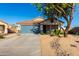 House exterior featuring a two-car garage and desert landscaping at 38617 N Jonathan St, San Tan Valley, AZ 85140