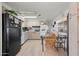 Kitchen with light wood cabinets, glass-top stove, and a dining area at 5201 W Camelback Rd # 204, Phoenix, AZ 85031