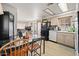 Kitchen features light wood cabinets, black appliances, and a view to the living area at 5201 W Camelback Rd # 204, Phoenix, AZ 85031