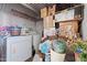 Small laundry room with washer, dryer, and storage shelves at 5201 W Camelback Rd # 204, Phoenix, AZ 85031