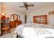 Well-lit bedroom with wooden furniture and a ceiling fan at 10408 W Sun City Blvd, Sun City, AZ 85351