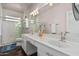 Elegant bathroom with double sinks, a walk-in shower, and marble tile at 959 W Myrtle Dr, Chandler, AZ 85248