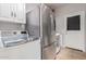 Bright laundry room with LG washer, dryer, and stainless steel refrigerator at 959 W Myrtle Dr, Chandler, AZ 85248